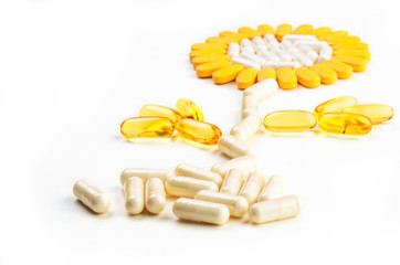 Group of vitamin pills - flower formed on white background - selective focus