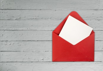 Blank card and envelope on a wooden background