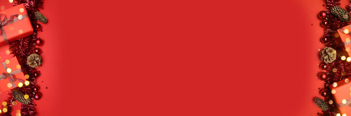 2025 Happy holidays greeting card with with shiny tinsel, gift boxes and balls on a red background...