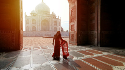 Indian woman in red saree/sari in the Taj Mahal, Agra, India