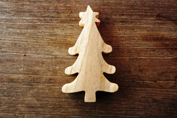 Christmas tree from wood handcraft lay on the table , vintage style.
