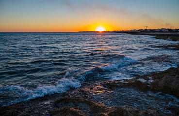 Tranquil sunset seascape with pink sky