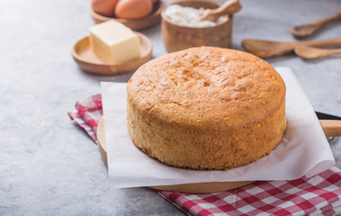 Homemade  Soft and lite delicious sponge cake with ingredients: eggs flour milk on stone concrete table. Bakery background concept.