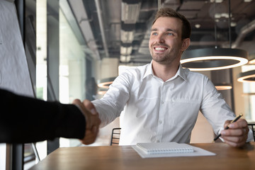 Close up of smiling Caucasian businessman handshake colleague
