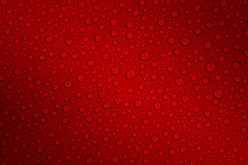 Wet with water drops dark red background with gradient illumination at two corners, closeup, details