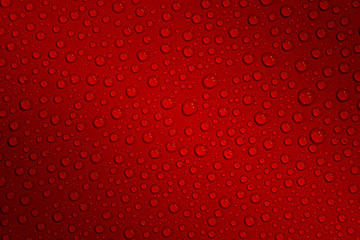 Wet with water drops dark red background with gradient illumination at two corners, closeup, details