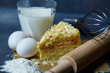 homemade Napoleon cake with cream on a gray background