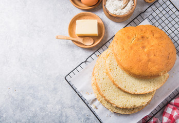 Homemade  Soft and lite delicious sponge cake with ingredients: eggs flour milk on stone concrete table. Bakery background concept.