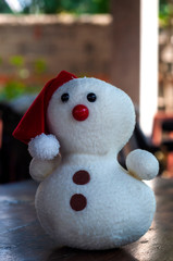A cute little teddy snowman toy for kids to play with.