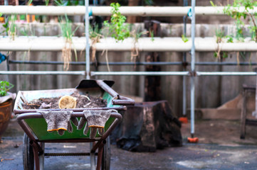 Worker gloves hanging on a trolley handle after a hard work. horizontal.
