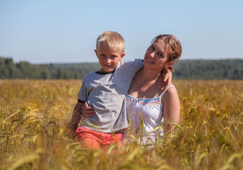 Happy mother and son in summer field