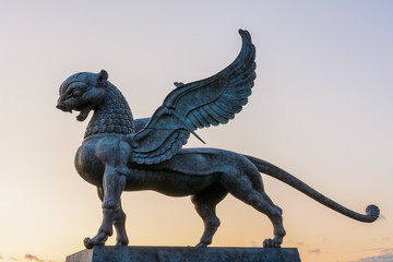 Fototapeta premium The sculpture of Ak Bars (Aq Bars, winged snow leopard), the symbol of Tatarstan at the Kazan wedding palace. Sunset.