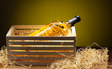 Fototapeta na wymiar Bottle of white wine in gift wooden box