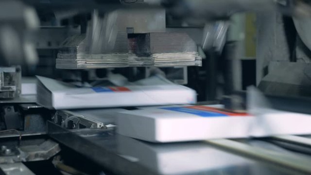 Books moving on a typographic conveyor, printing office.