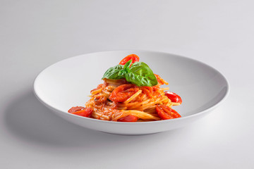 Elegant White round bowl with spaghetti tomato and basil