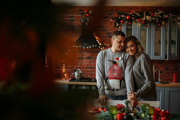 Obraz na płótnie Canvas kisses in the kitchen. christmas morning