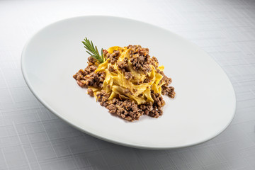 Elegant White round bowl with tagliatelle Bolognese