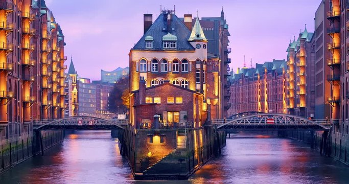 Hamburg, Germany. The Warehouse District (German: Speicherstadt) at dusk. View of Wandrahmsfleet. The largest warehouse district in the world is located in the port of within the HafenCity quarter.