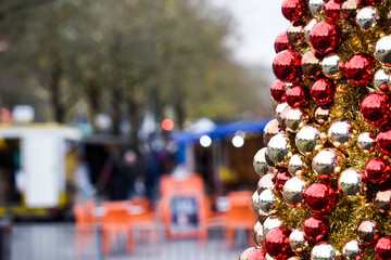 Christmas shopping a view of a high street with shops and retail christmas market in the background