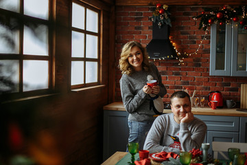 family drinks tea in the kitchen. christmas morning