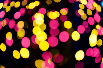 Defocused christmas garlands with colorful glow. Christmas background with multicolored bokeh.