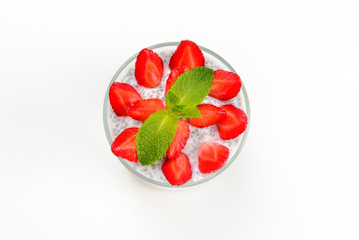 Chia pudding with strawberry and mint on a white background. Space for text or design.