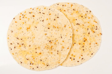 Pitta bread with seeds isolated on white