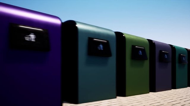 A colored row of iron garbage bins against a clear blue sky. Waste sorting and saving the environment. 4k
