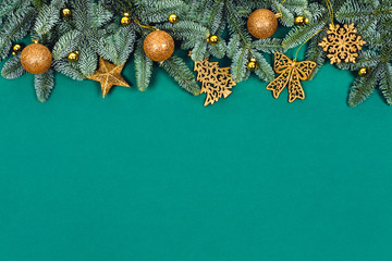 Christmas green background with golden toys.