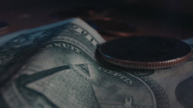 US dollar bills & quarter coins, change on table