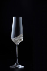 Glass with sparkling champagne at black background, magazine and commercial photo with space for text or design, festive and celebrating food and drink photography