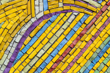 texture of multi-colored stones. Background from vintage mosaic on the wall.