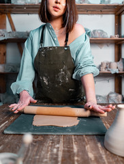 Cropped Photo of Attractive Woman Dressed In Green Stylish Apron Holding Rolling Pin and Making Clay Dish