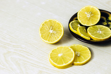 lemon slices neatly cut and lie on a wooden background. space for text