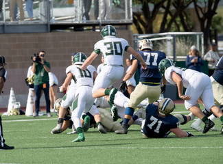 Action photos of high school football players making amazing plays during a football game