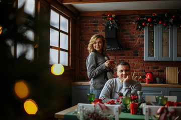 Obraz na płótnie Canvas husband and wife drink tea in the kitchen