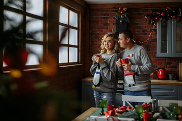 husband and wife drink tea in the kitchen