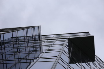 Abstract business modern city urban futuristic architecture background, motion blur, reflection in glass of high rise skyscraper facade, toned blue picture with bokeh. Real estate concept