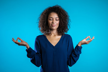 Calm student girl or businesswoman relaxing, meditating. Woman calms down, breathes deeply with...