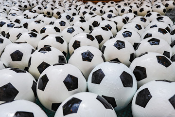 Background of floating footballs in a fountain.