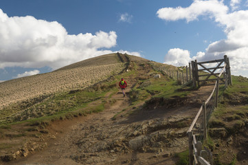A runner running along the Mam Tor Trail in the Peak District, Derbyshire