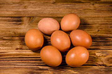 Pile of the hen eggs on wooden table