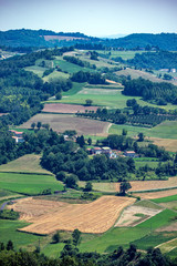 Naklejka premium landscape with green fields and hills, aerial view over italy, piemonte