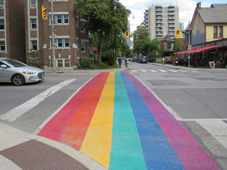 Toronto Canada; August 24, 2019: crosswalk painted with the LGBT flag, gay pride flag; Rainbow