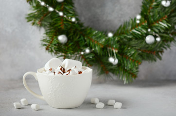 Obraz na płótnie Canvas Cup of hot chocolate with marshmallows on a gray concrete background. Christmas concept.