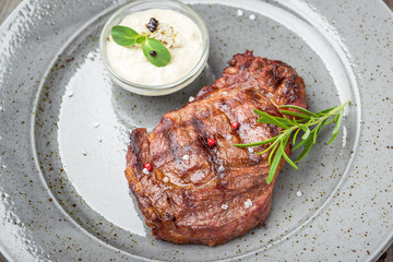Tenderloin steak on plate with sauce