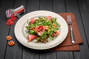 salad with parma ham jamon , tomatoes and arugula