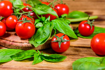 Heap of small cherry tomatoes on wooden table