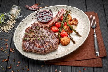 Grilled meat and vegetables on rustic wooden table