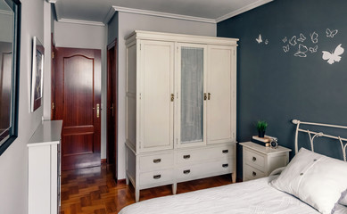 Elegant furnished double bedroom with bed, bedside table and closet